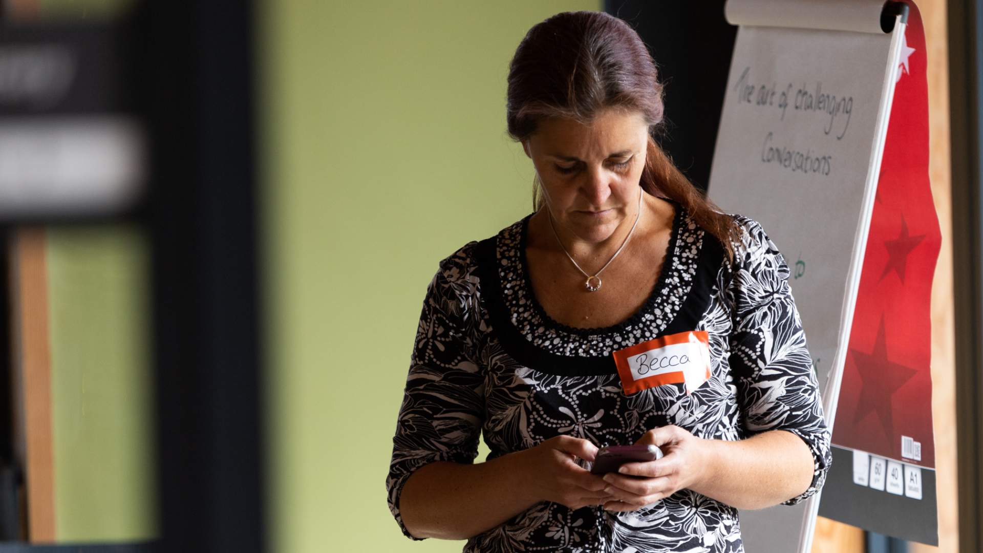 Becca is checking her mobile phone during a break between the workshops she facilitated at the Big Day Out 2022