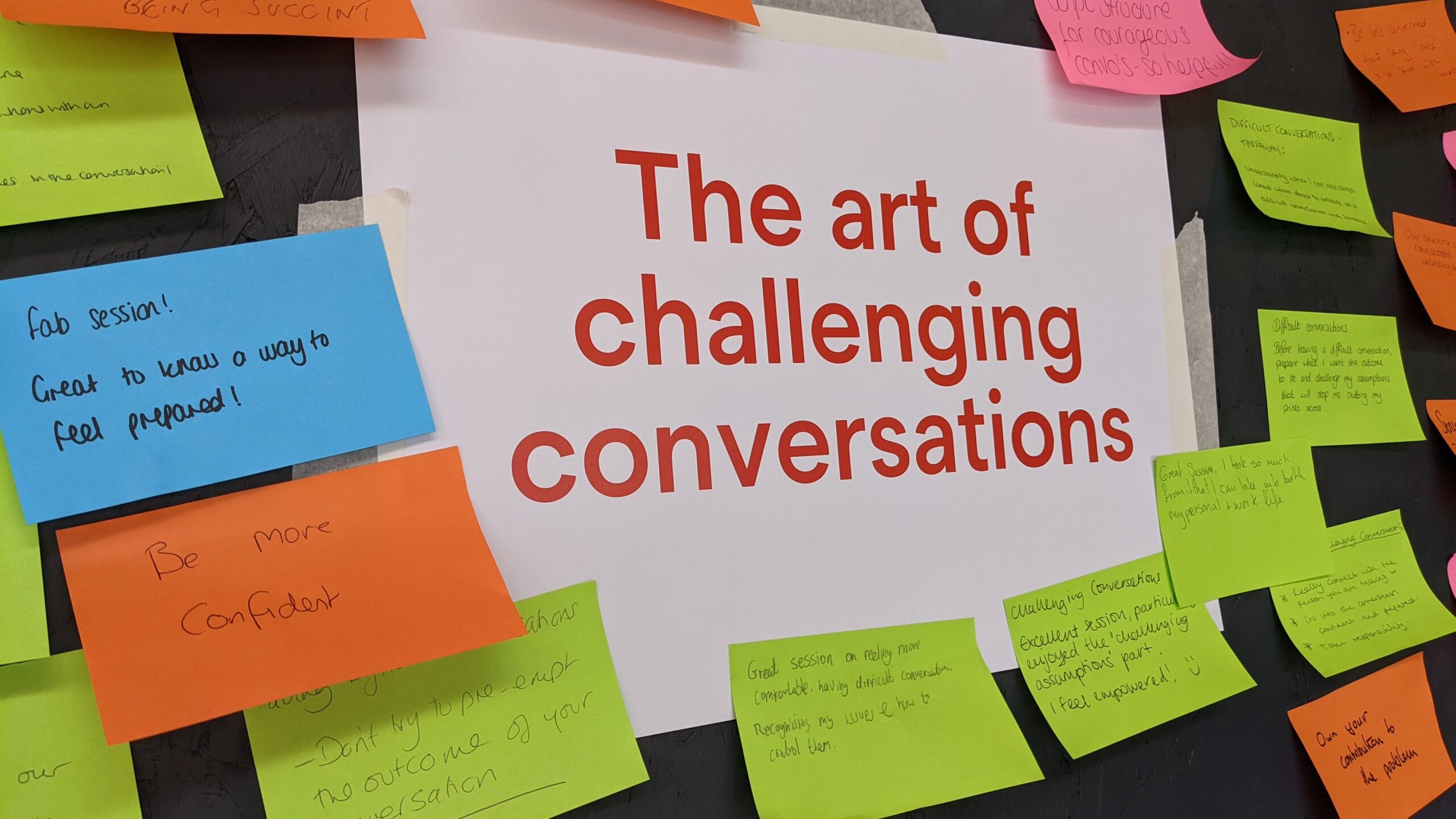 The phrase 'The art of challenging conversations' is placed at the centre of the image and is surrounded by multi-coloured post-it notes with handwritten observations and comments added by participants in the workshop session
